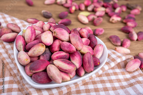 Fresh raw pistachio nuts in shell natural background. Fresh pistachios for sale at a street market. Turkish known as 