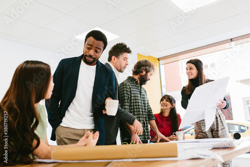 Black male chatting with colleague in office photo