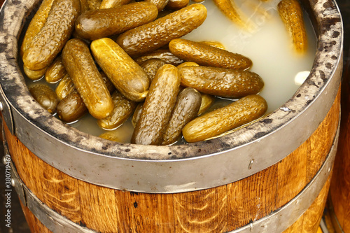 Cucumber pickles in a wooden barrel in the food market