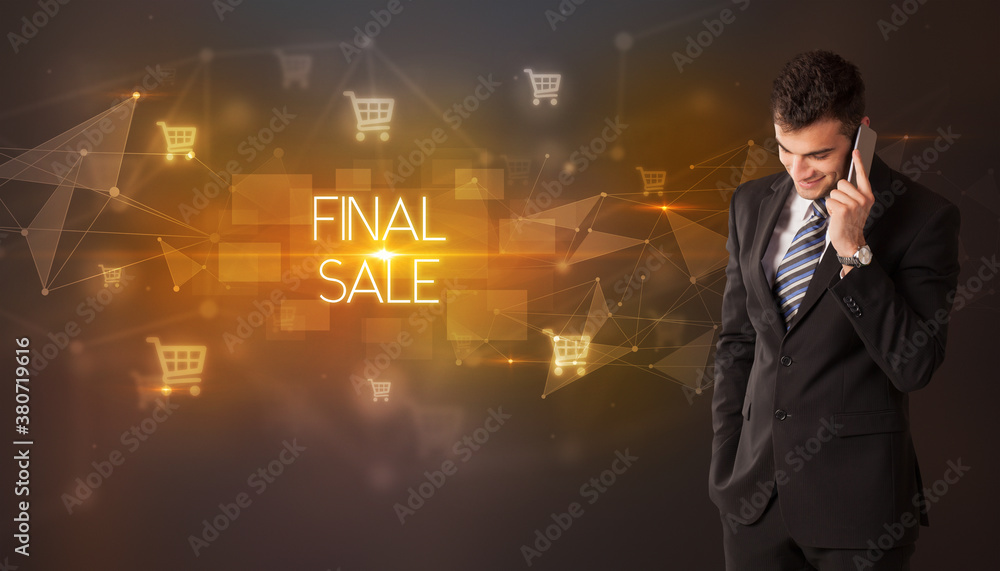 Businessman with shopping cart icons and FINAL SALE inscription, online shopping concept Businessman with shopping cart icons and FINAL SALE inscription, online shopping concept