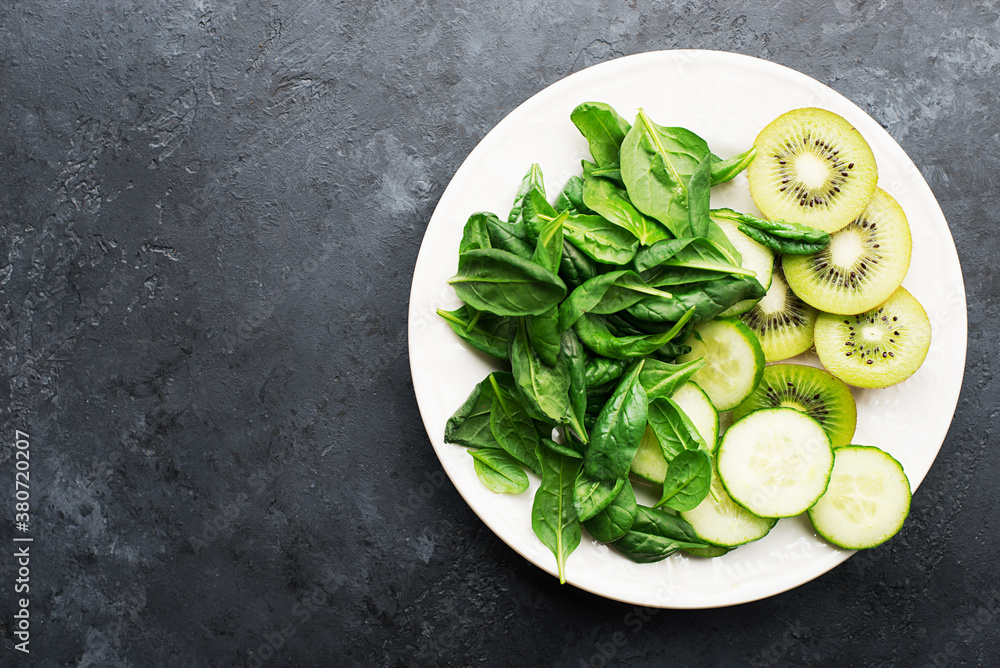 Green fruit vegetables summer detox bowl of salad. Avocado, spinach, cucumber, micro greens, blueberries one plate dish. Top View Green fruit vegetables summer detox bowl of salad. Avocado, spinach, cucumber, micro greens, blueberries one plate dish. Top View