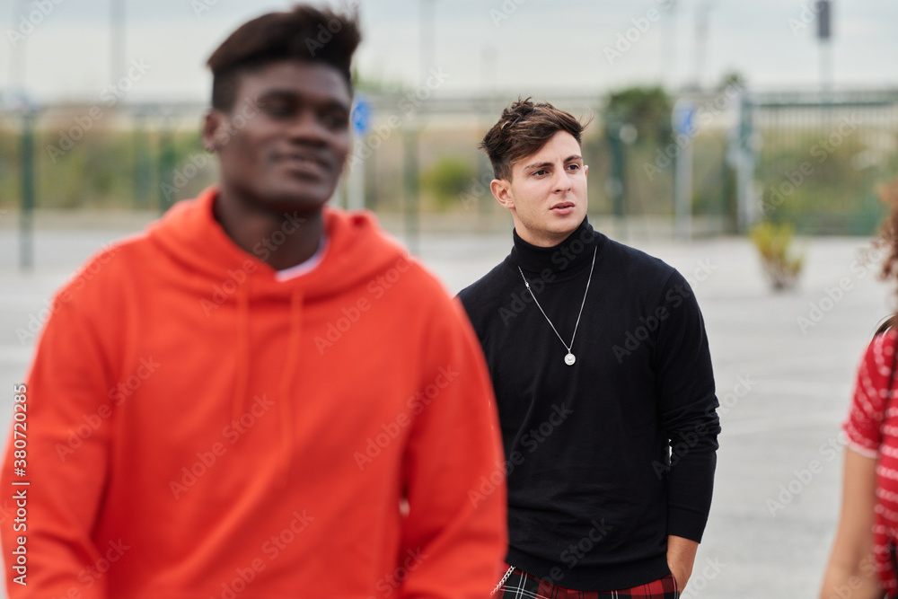 Buddies standing on empty parking space Buddies standing on empty parking space