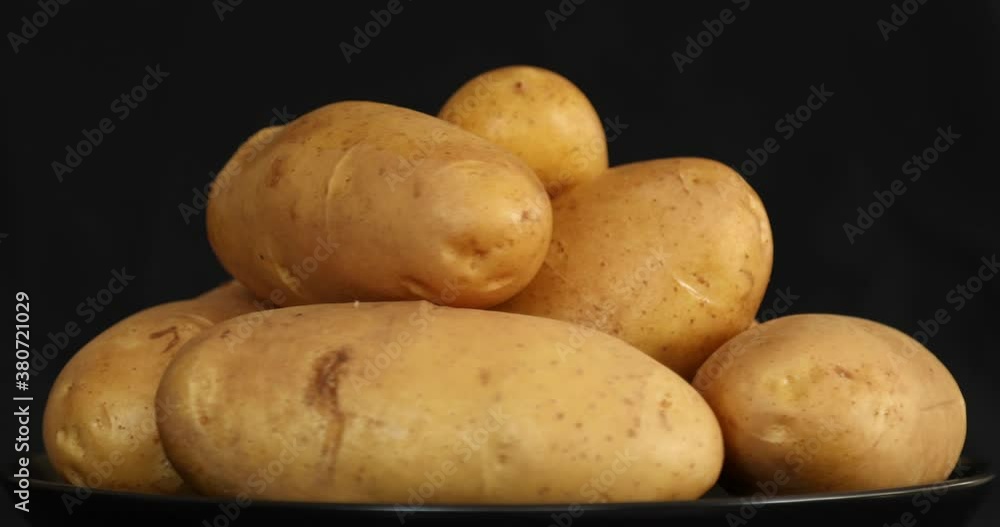 Raw Potatoes Spinning and Rotating Isolated on Black Background Raw Potatoes Spinning and Rotating Isolated on Black Background