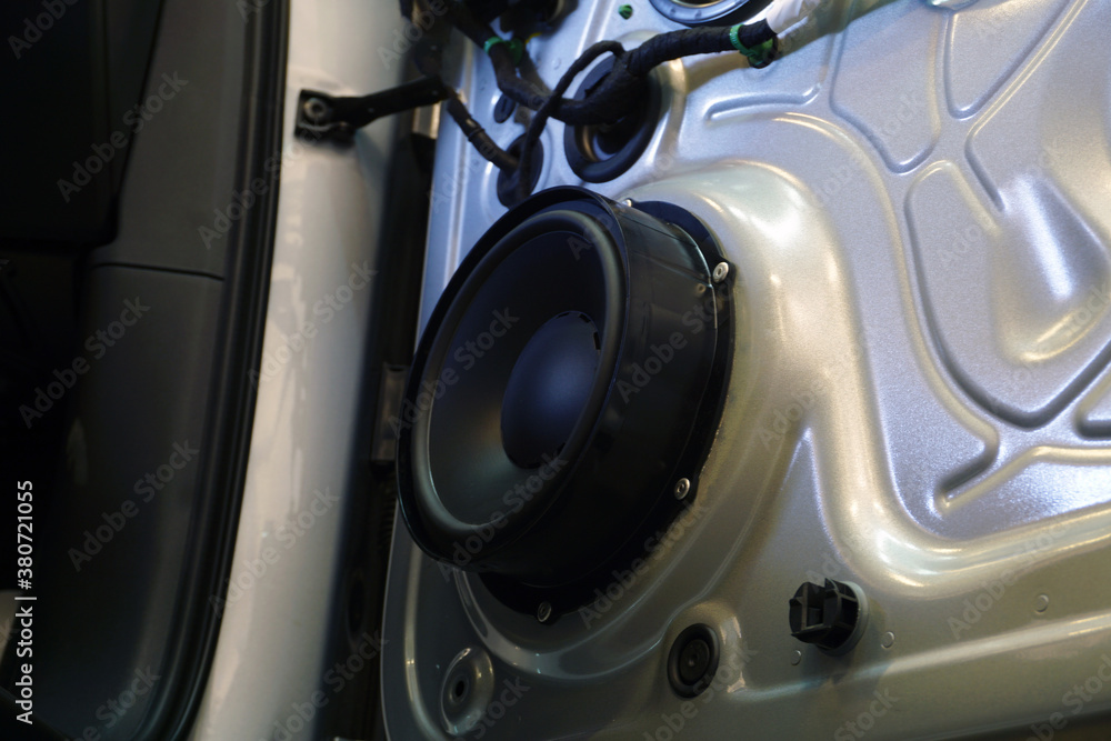 The inner lining has been removed from the door of a modern car. You can see the wiring and the music speaker. Car service and electrodiagnostics Concept. The inner lining has been removed from the door of a modern car. You can see the wiring and the music speaker. Car service and electrodiagnostics Concept.