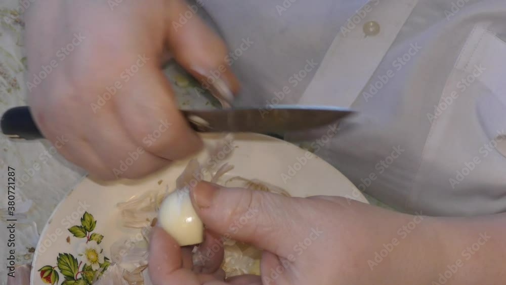 the cook cleans the garlic. healthy food concept the cook cleans the garlic. healthy food concept