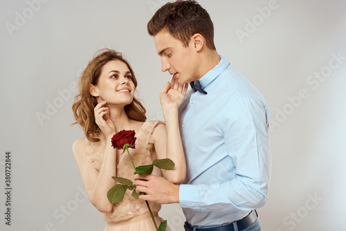lovers men and woman hugs romance love red rose light background
