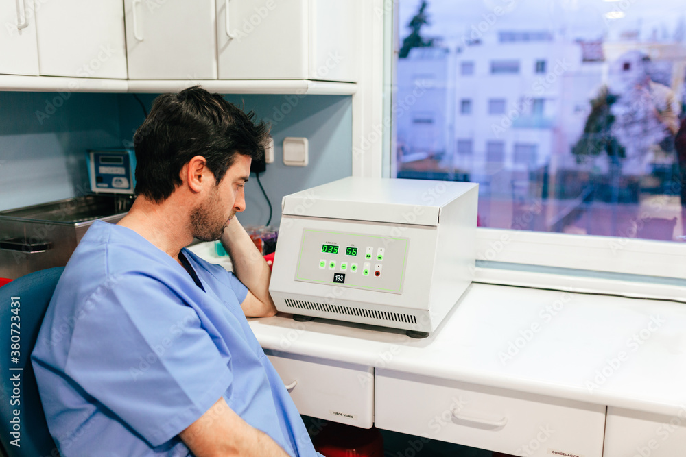 Tired biologist working in professional laboratory Tired biologist working in professional laboratory