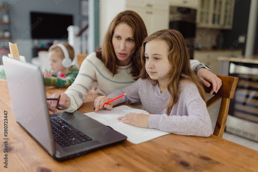 Mother helping daughter with school work Mother helping daughter with school work