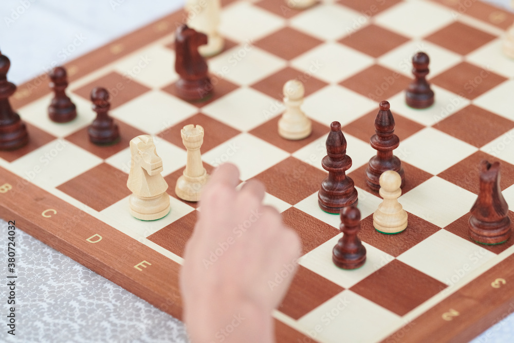 Hand at chessboard Hand at chessboard