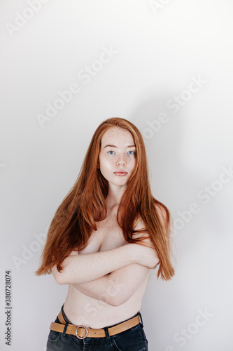 Topless redhead young woman with freckles photo