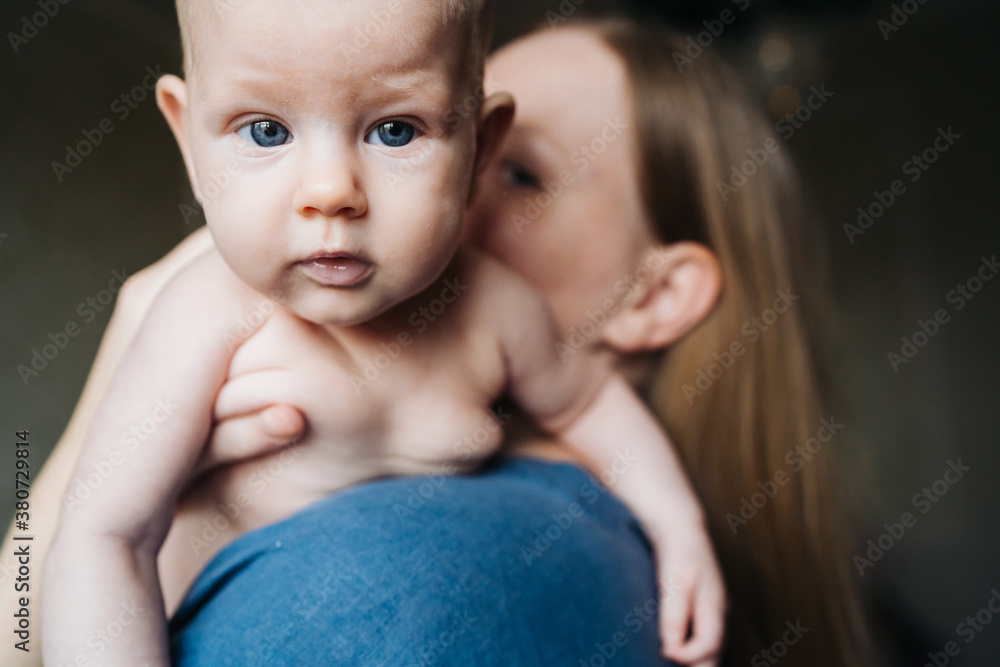 Woman, Breastfeeding A Baby, baby looking at camera Woman, Breastfeeding A Baby, baby looking at camera