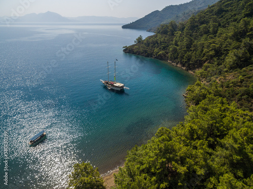 A few boat anchored in a peaceful cove photo