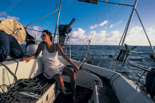 a sailor is holding the tiller while sailing photo