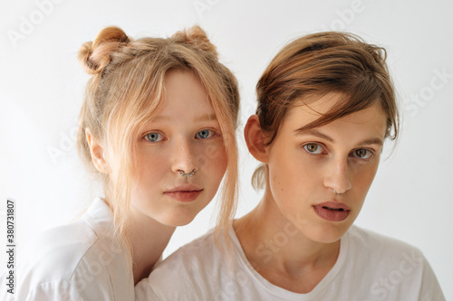 portrait of two beautiful young girls on a white background