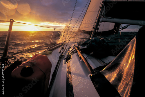 long haul sailboat sailing into the sunset photo