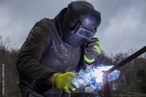 A man is welding outdoors photo