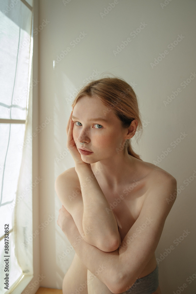 portrait of a charming blonde by the window portrait of a charming blonde by the window