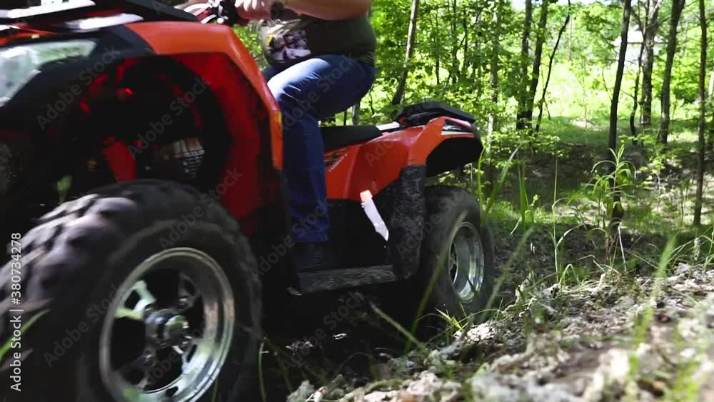 Long shot. Slowmotion. Guys, men on an ATV ride up the hill. Quad bikes in the forest. Quad bike ride. Active rest on ATVs. Long shot. Slowmotion. Guys, men on an ATV ride up the hill. Quad bikes in the forest. Quad bike ride. Active rest on ATVs.