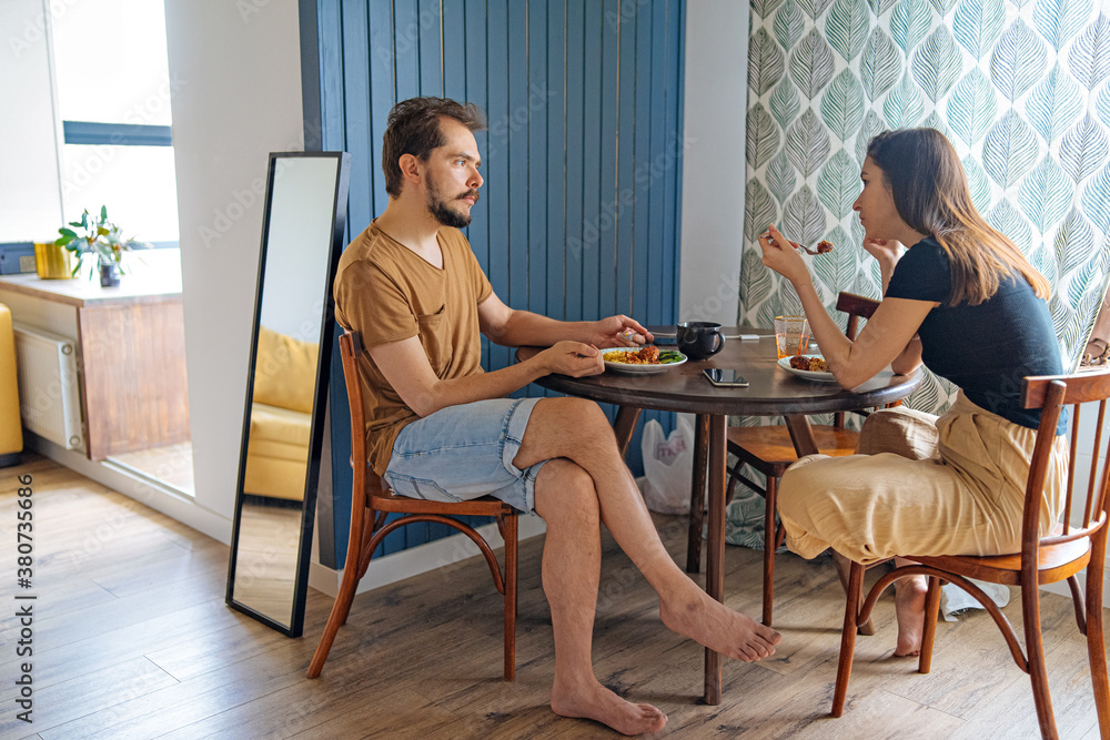 couple having lunch at a table in the kitchen couple having lunch at a table in the kitchen