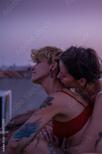 It is a summer day and this lovely couple has decided to see the sunset from the rooftop.