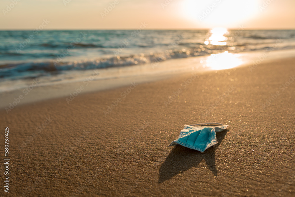 Waste during COVID-19 Spain. Discarded to ocean coronavirus single-use face mask Waste during COVID-19 Spain. Discarded to ocean coronavirus single-use face mask