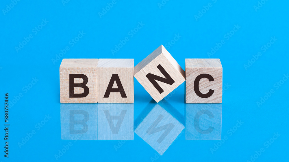Bank text on wooden blocks, financial business concept, blue background Bank text on wooden blocks, financial business concept, blue background