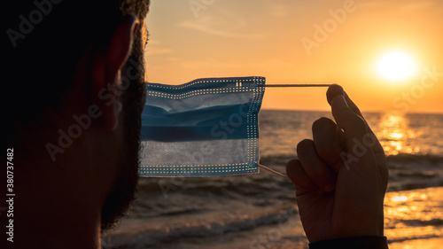COVID-19 Caucasian man in a beach wearing face mask protective for coronavirus. © REC Stock Footage