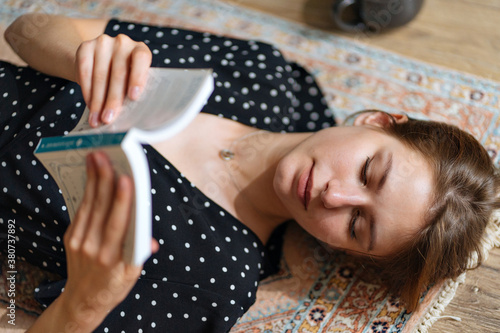 close-up of a young woman reading a book photo