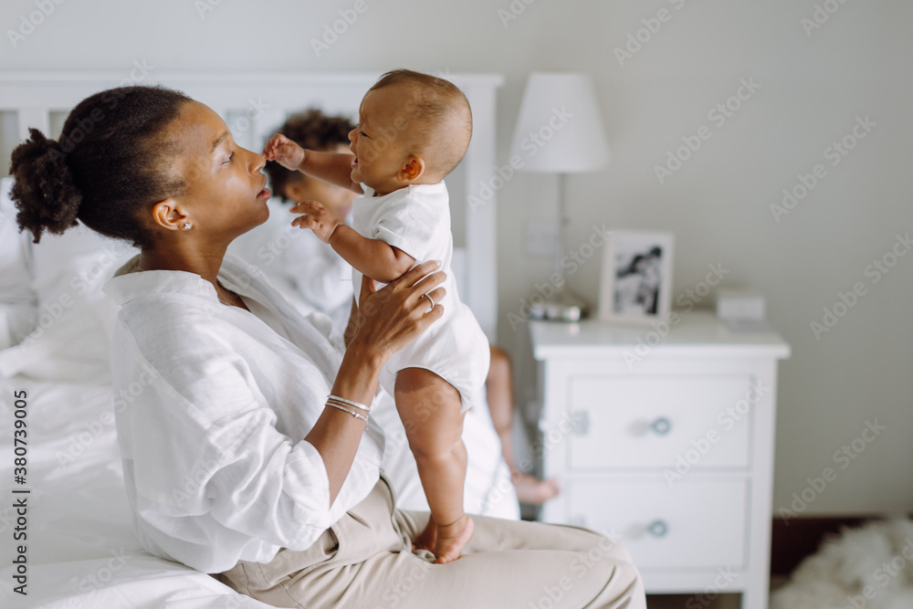 Mother with a baby and an older son in the bedroom Mother with a baby and an older son in the bedroom