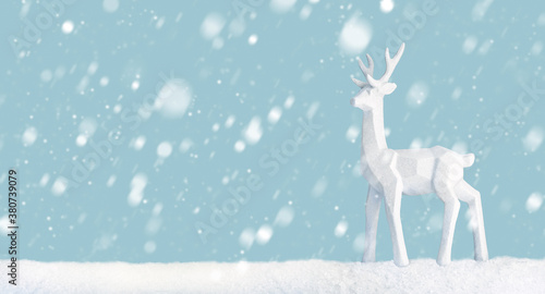 Scene of a deer in a snowy landscape with light blue background © Formatoriginal