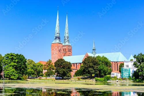 Catherdal church (Dom) with a lake, blue sky in Lubeck (Lübeck), Schleswig-Holstein, Germany.