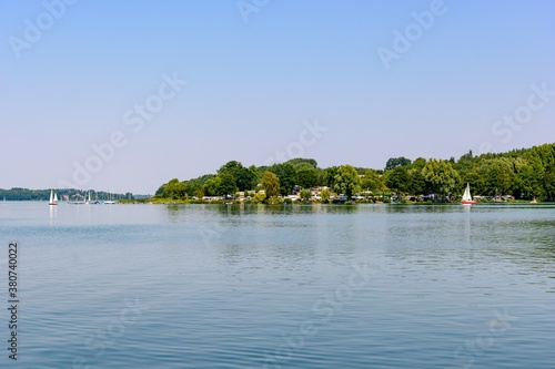 Idyllic view on Ratzenburger See. Lake with boats, sailboats, blue sky. Schleswig Holstein, Ratzenburg, Germany.