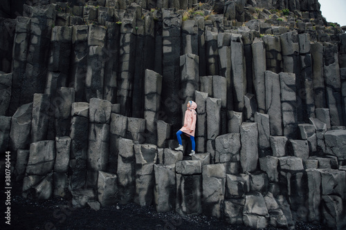 Woman standing on basalt rock formations