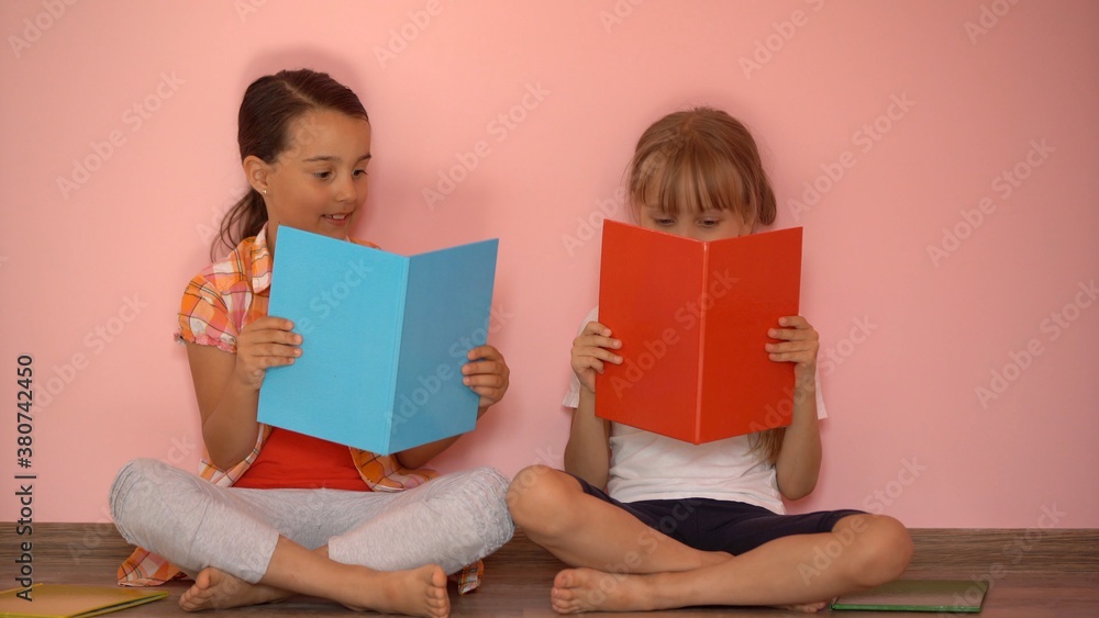education and school concept - little student girls studying and reading book at home education and school concept - little student girls studying and reading book at home