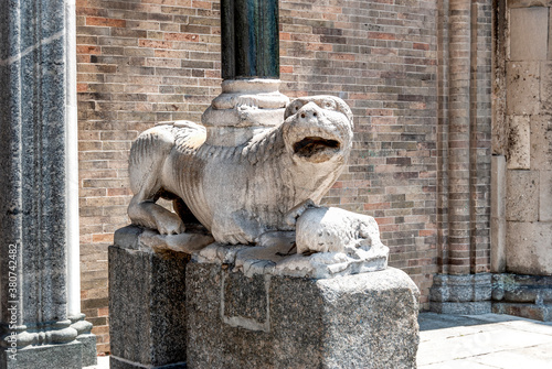 A marble column-bearing lion (stylophore lion) in front of Lodi Cathedral dedicated to the Assumption of the Blessed Virgin Mary, in Lodi, Lombardy region, northern Italy. photo