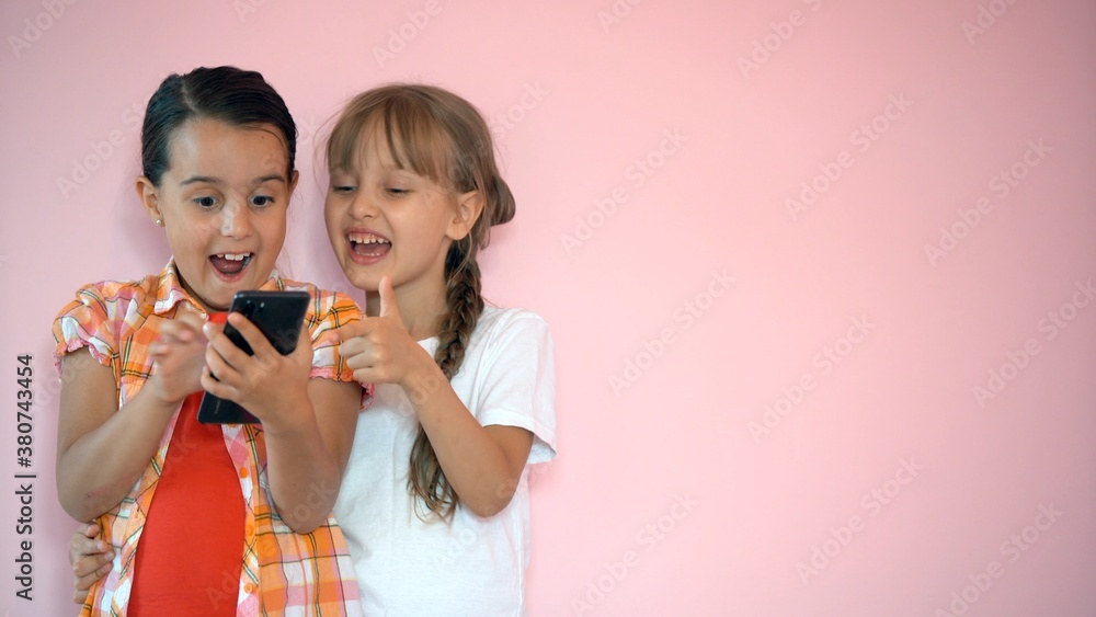 Portrait of two nice-looking attractive charming cute lovely friendly cheerful pre-teen girls isolated on pink pastel background Portrait of two nice-looking attractive charming cute lovely friendly cheerful pre-teen girls isolated on pink pastel background