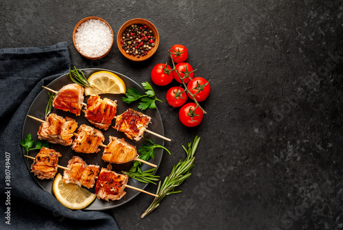 Delicious grilled salmon kebab on a stone background. Salmon kebab with copy space for your text
