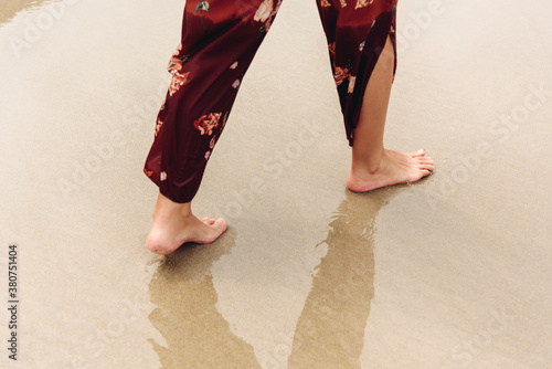 Close-up of a woman's bare feet on the seashore photo