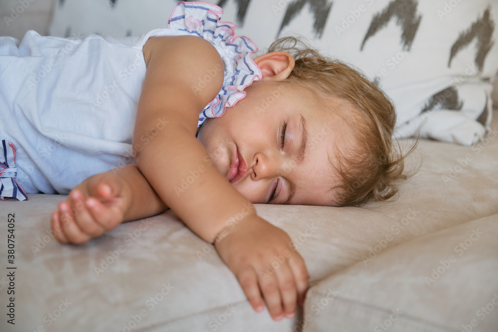 Little girl sleeping on the couch of a house Little girl sleeping on the couch of a house