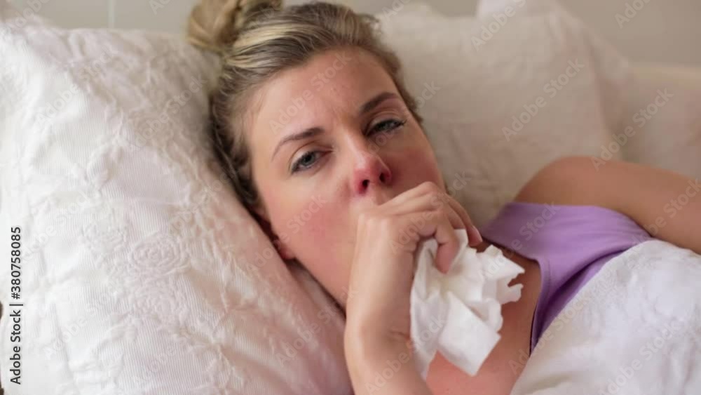 A woman having a video appointment with her doctor while laying sick in bed, webcam POV A woman having a video appointment with her doctor while laying sick in bed, webcam POV