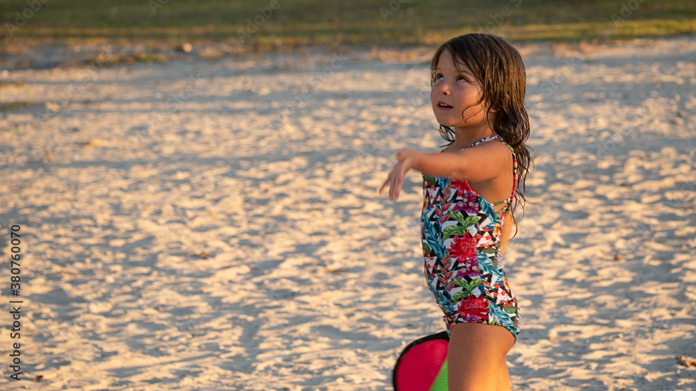 Fototapeta premium Little Girl Playing in the Beach