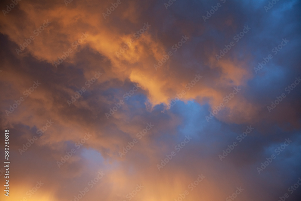Dramatic Storm Clouds at Sunset with Gold, Orange and Purple Coloring