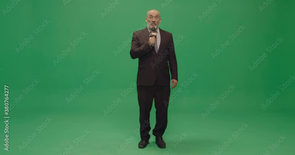 Studio, slow motion, green screen, a mature male reporter talks at camera, London, UK Studio, slow motion, green screen, a mature male reporter talks at camera, London, UK