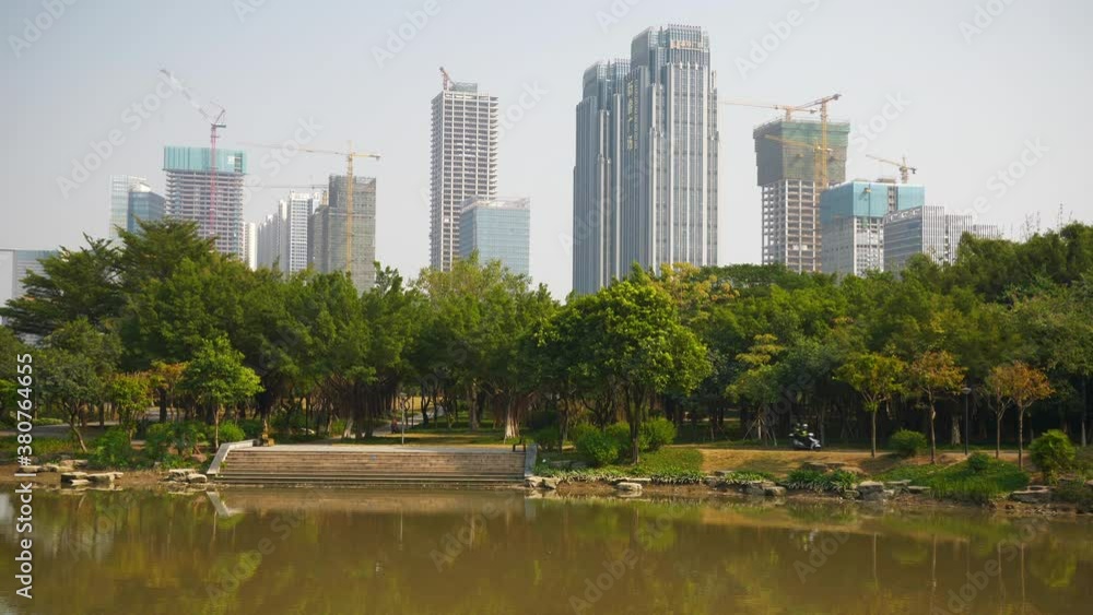 day time foshan city park pond residential complex construction slow motion panorama 4k china day time foshan city park pond residential complex construction slow motion panorama 4k china