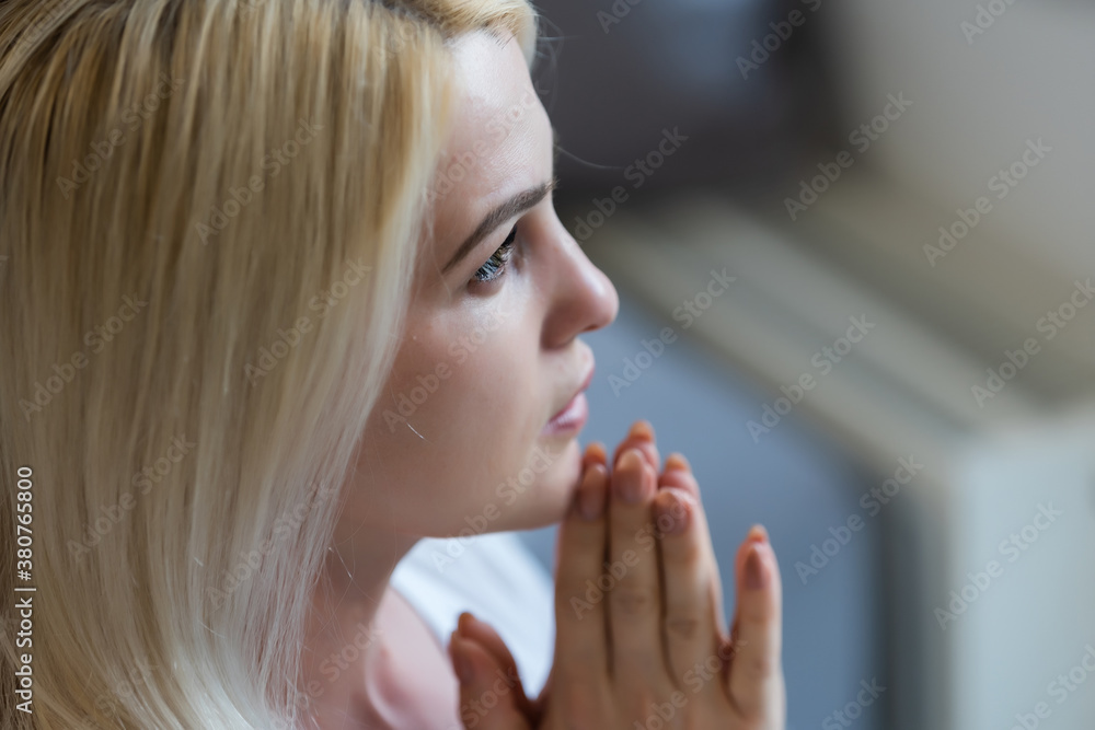 Closeup portrait of a young caucasian woman praying Closeup portrait of a young caucasian woman praying