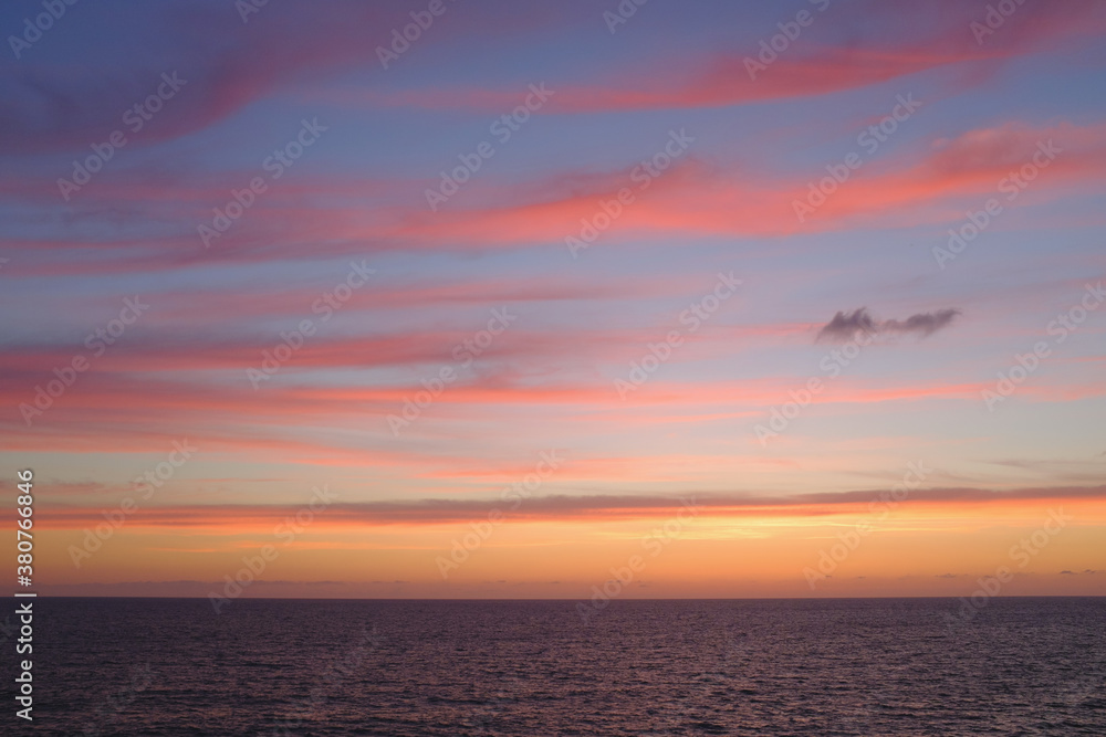 Seascape with stripes of clouds during sunset Seascape with stripes of clouds during sunset