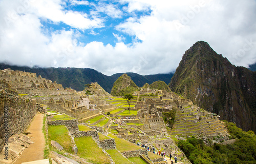 View of a tour group visiting Macchu Picchu, Peru.