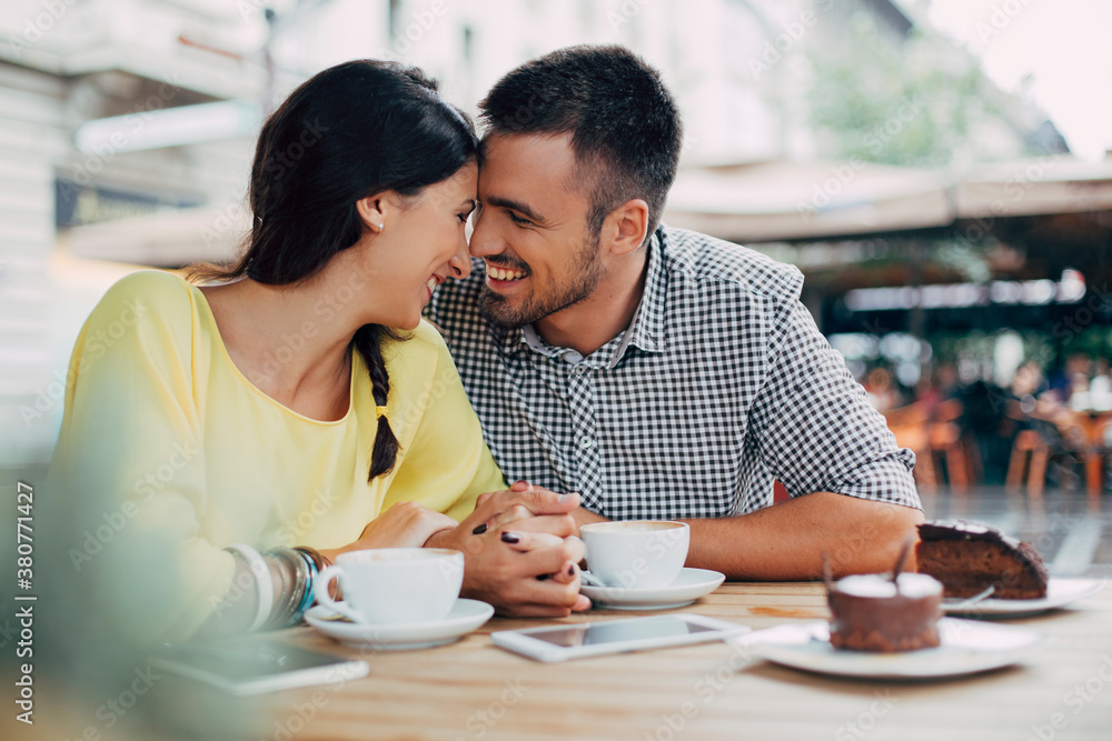 Smiling Couple in Love Sitting at a Cafe Smiling Couple in Love Sitting at a Cafe