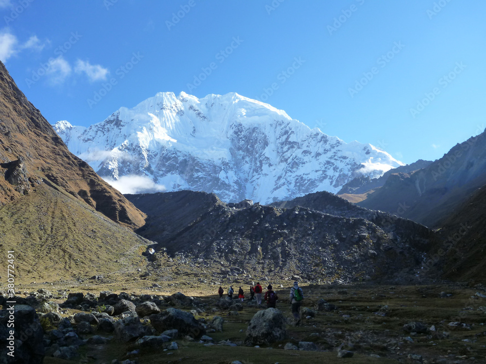 Hikers on the Salkantay trek in Peru, with snow capped mountains in the distance