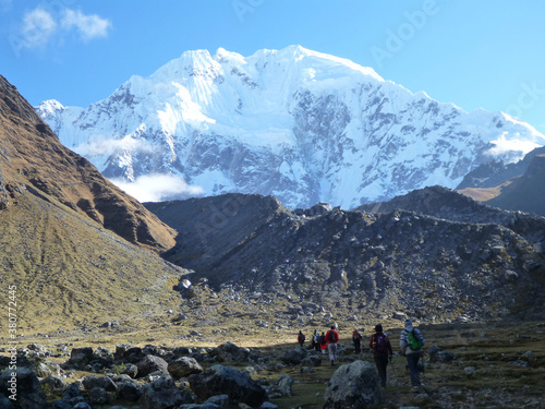 Hikers on the Salkantay trek in Peru, with snow capped mountains in the distance